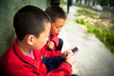 Chinese kids playing with phone