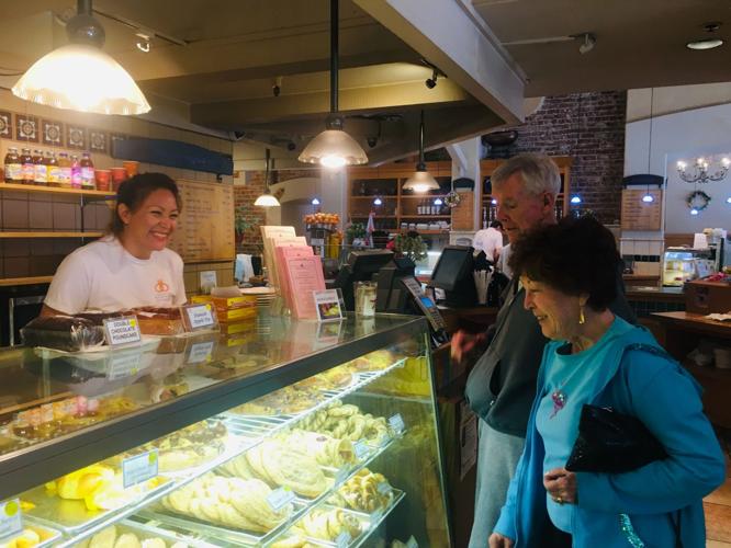 Nancy Cervera, 21-year Copenhagen Bakery & Cafe employee, helps Barbara & John Nevin, long-time customers and Millbrae residents.jpg