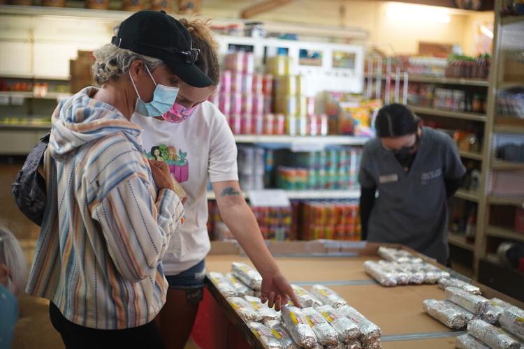 Customers, Elizabeth Woods and Kimberly Booker, look through the display of musubi at Takahashi Market in San Mateo.JPG