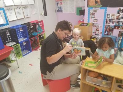 Emergency dispatcher reads to local kids