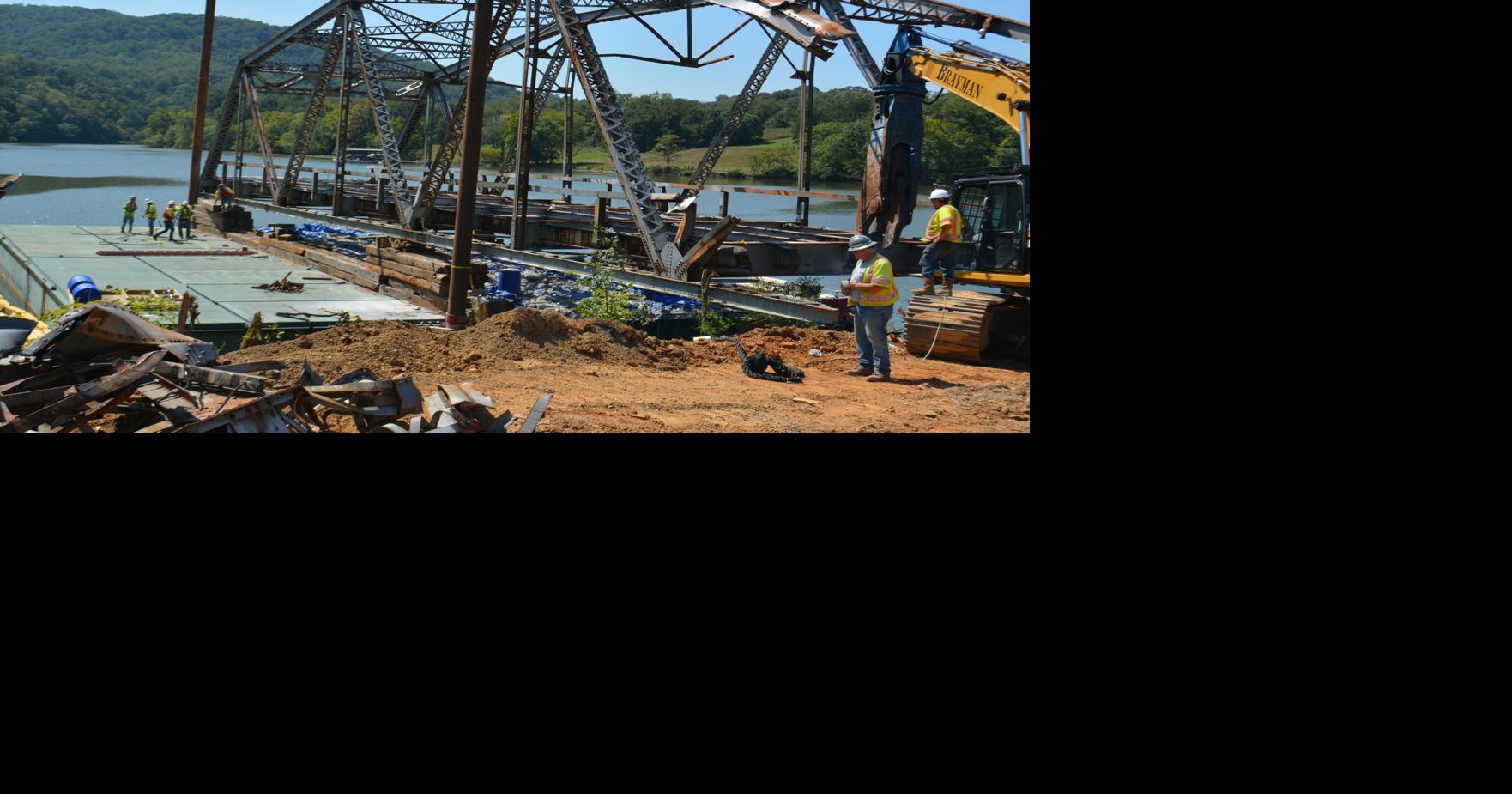Workers remove old bridge piece by piece