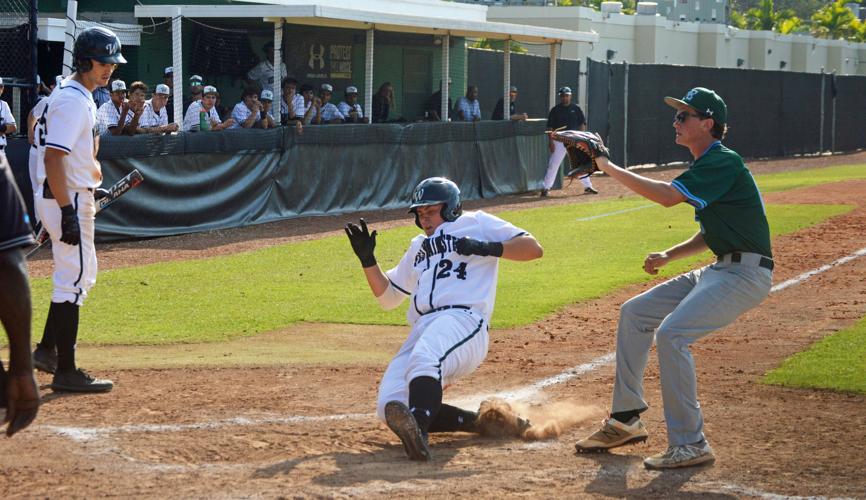 Kevin Martin sliding in safely with Lucas Costello watching