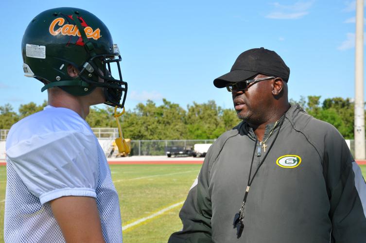 Coach Alphonso Bryant working with player at Coral Shores practice