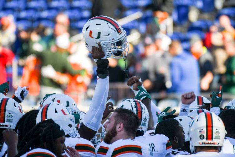 The Canes celebrate on the sidelines in Durham.