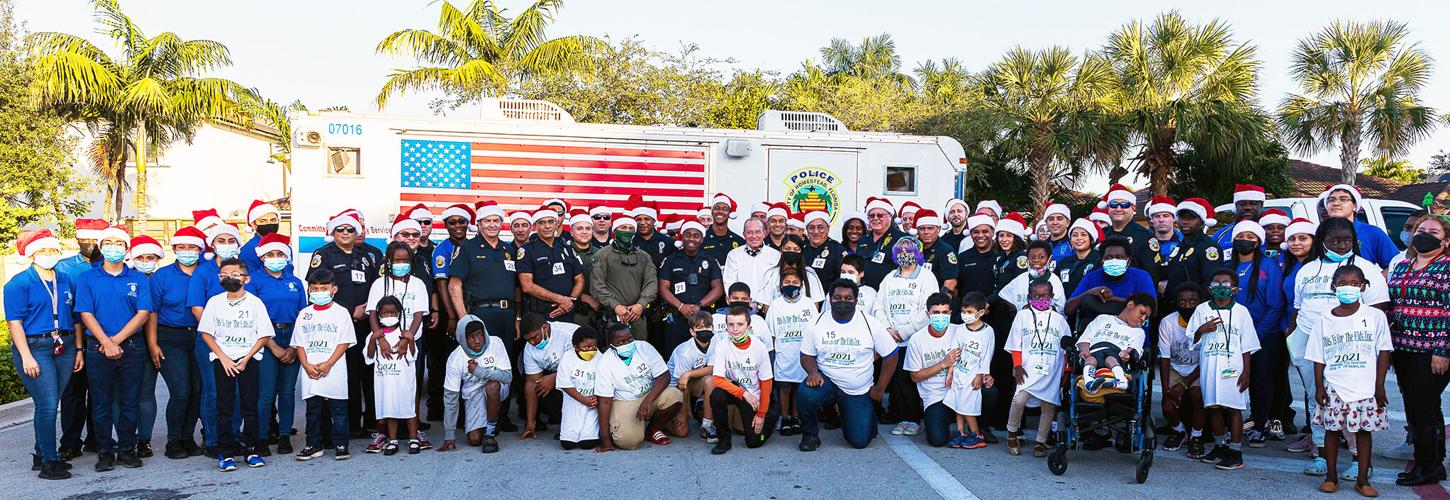 Councilman Roth is joined by the many officers and volunteers along with many of the kids selected for the event.
