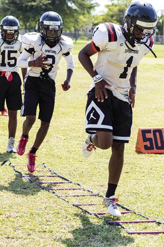 Wide Receiver Mark Pope leads receivers in  ladder drills during Miami’s Southridge’s spring practice