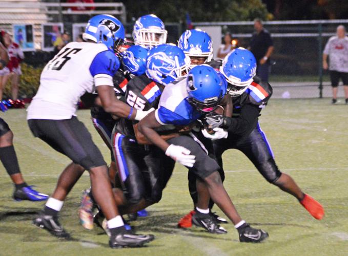 South Dade’s Willie Thomas carries a few players with him.