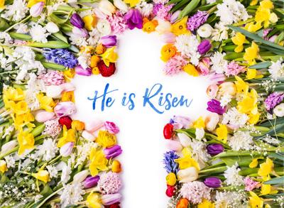 A cross on a colorful flower background. Easter flat lay.