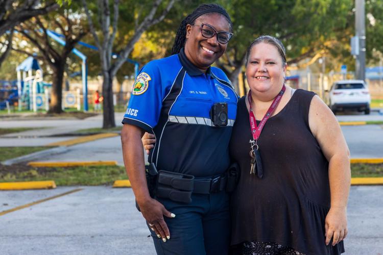 Homestead Community Policing Officer Shanell Wadley who is Chief Advisor to Homestead Police Explorer Post 47 stands next to Amanda Coleman who delivered the surprise spaghetti dinner to the Post.