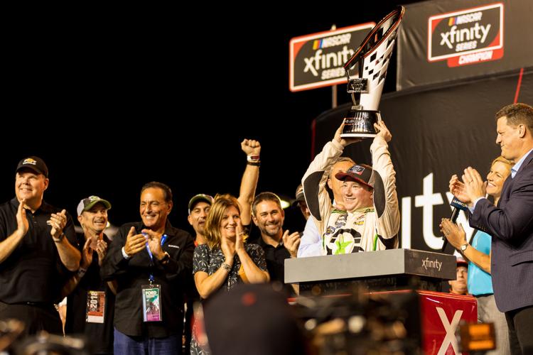 Tyler Reddick lifts the Xfinity series trophy.