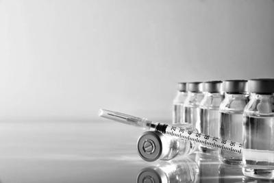 Vials group and syringe on table with blue background