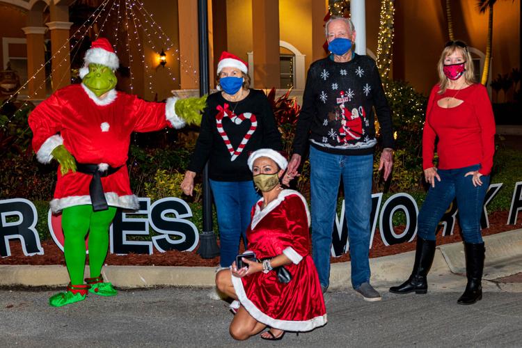 Susan Sorrentino as the Grinch and her sister Kim Hart standing, came to celebrate with their parents, Charles and Mary Pender (center). Giulia Covella, Palace  Gardens Manger, (in front) joined them .