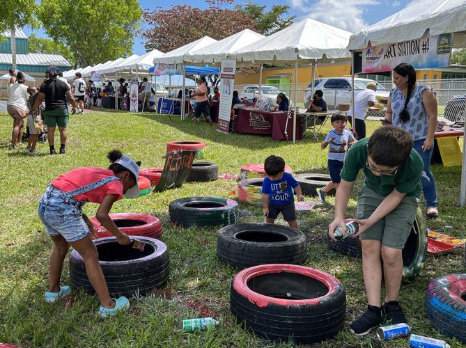 Art is often not on canvas at ArtWalk stations. Last year, Florida City set up old tires and had plenty of paint for children  to come up with their own ideas for  decorating.