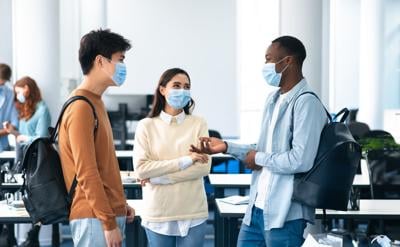 students wearing medical masks and talking