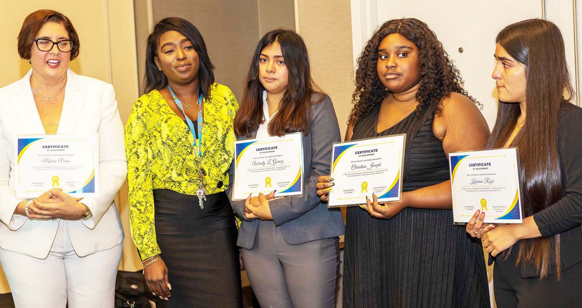 From left:  Amy Christopoulos and Shaundre Dixon present Wendy Gomez, Christina Joseph, and Karina Rojo with their certificates. All three students worked to be awarded multiple scholarships and will be attending Florida International University.