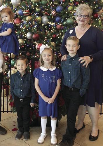 Doris Meneses, with a few of her grandchildren.