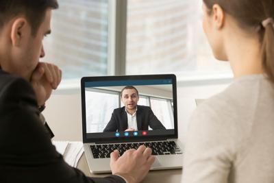 Businesspeople holding online meeting on laptop, making video ca