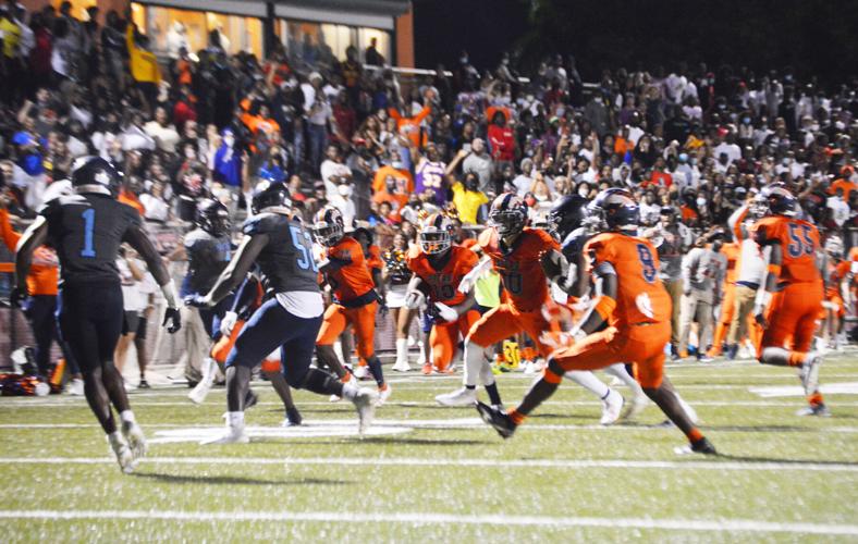 Senior Noah Lyons runs the ball as the crowd, with over 2100 in the stands, cheers him on.