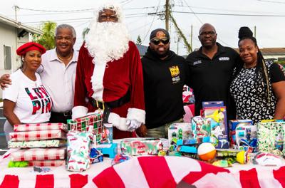 Santa is joined by Bishop Irene Harris, Mayor Otis Wallace, John Mays,  Commissioner James Gold and his wife Tasha.
