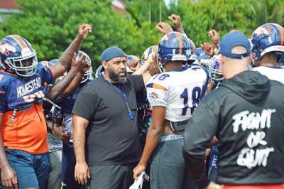 Head Coach Philip Simpson gets the team together at practice on Tuesday.