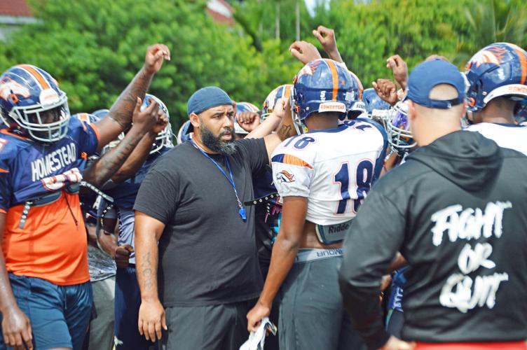 Head Coach Philip Simpson gets the team together at practice on Tuesday.