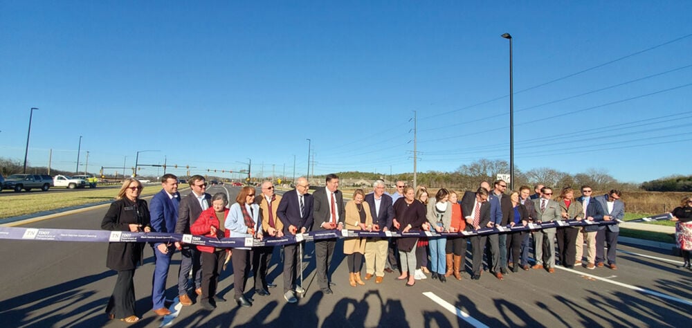 Local and state elected officials joined with TDOT officials and construction and design workers to cut the ribbon on the Mack Hatcher Parkway extension