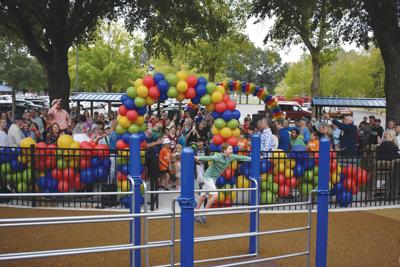 Miles Peck leads the way into the Miles Together Inclusive Playground in Brentwood's Granny White Park
