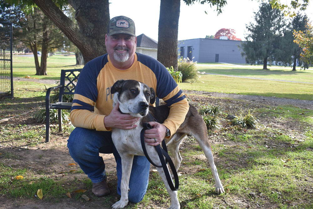 Mark Doetzer, of Brentwood, adopts his new dog Arlo