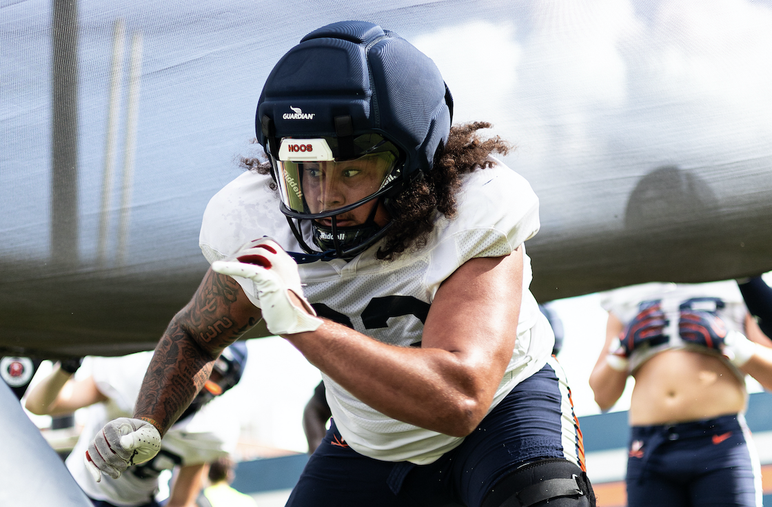 Virginia football defensive veterans Jacob Holmes and Cazeem Moore training on the field