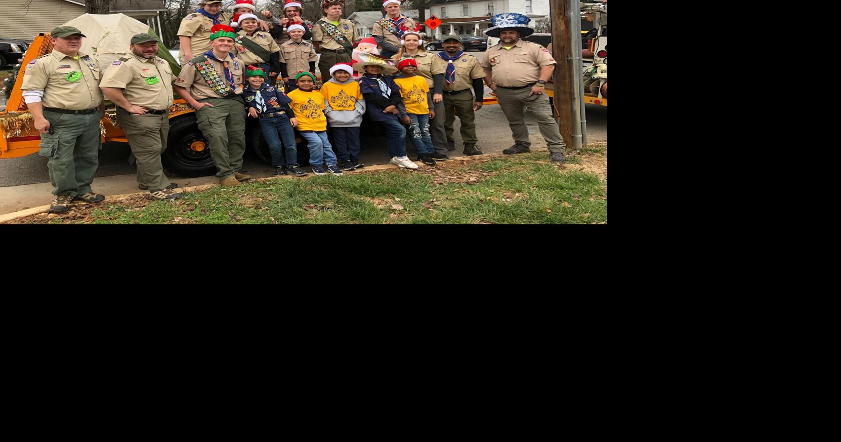 Cub and Boy Scout troops hand out candy from Campfire float