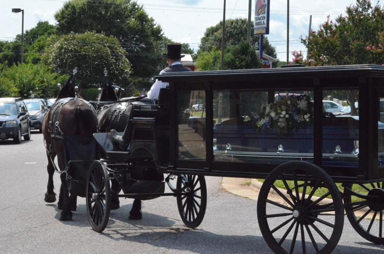 A horse drawn hearse takes Ah'Miyahh Howell to Iredell Memorial Park in Statesville on Saturday.