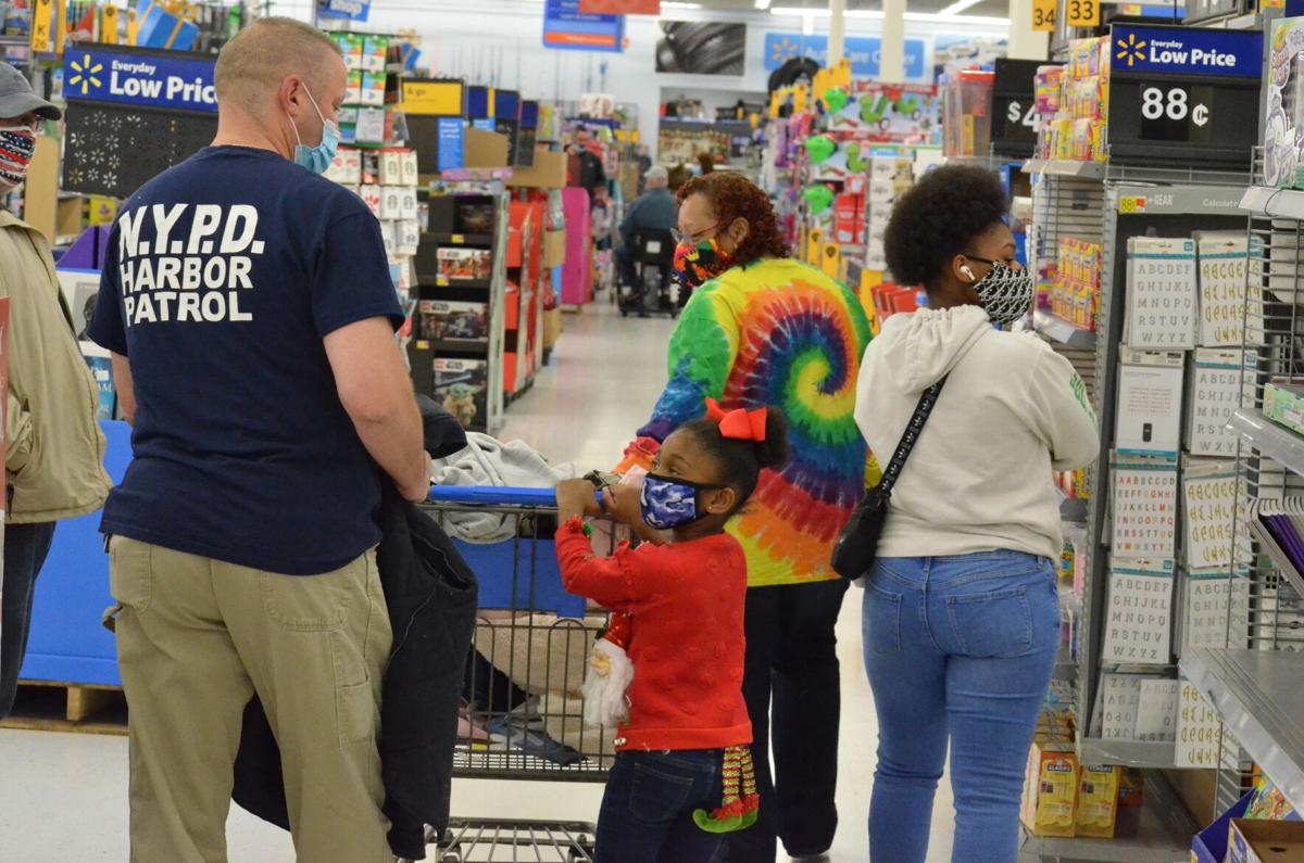 Vinny Slavik shops with the Murdock family during the annual Cops and Kids shopping program sponsored by the Iredell County Fraternal Order of Police.