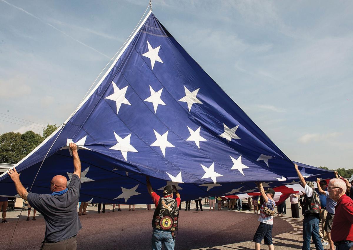 PHOTOS Camping World raises giant American Flag