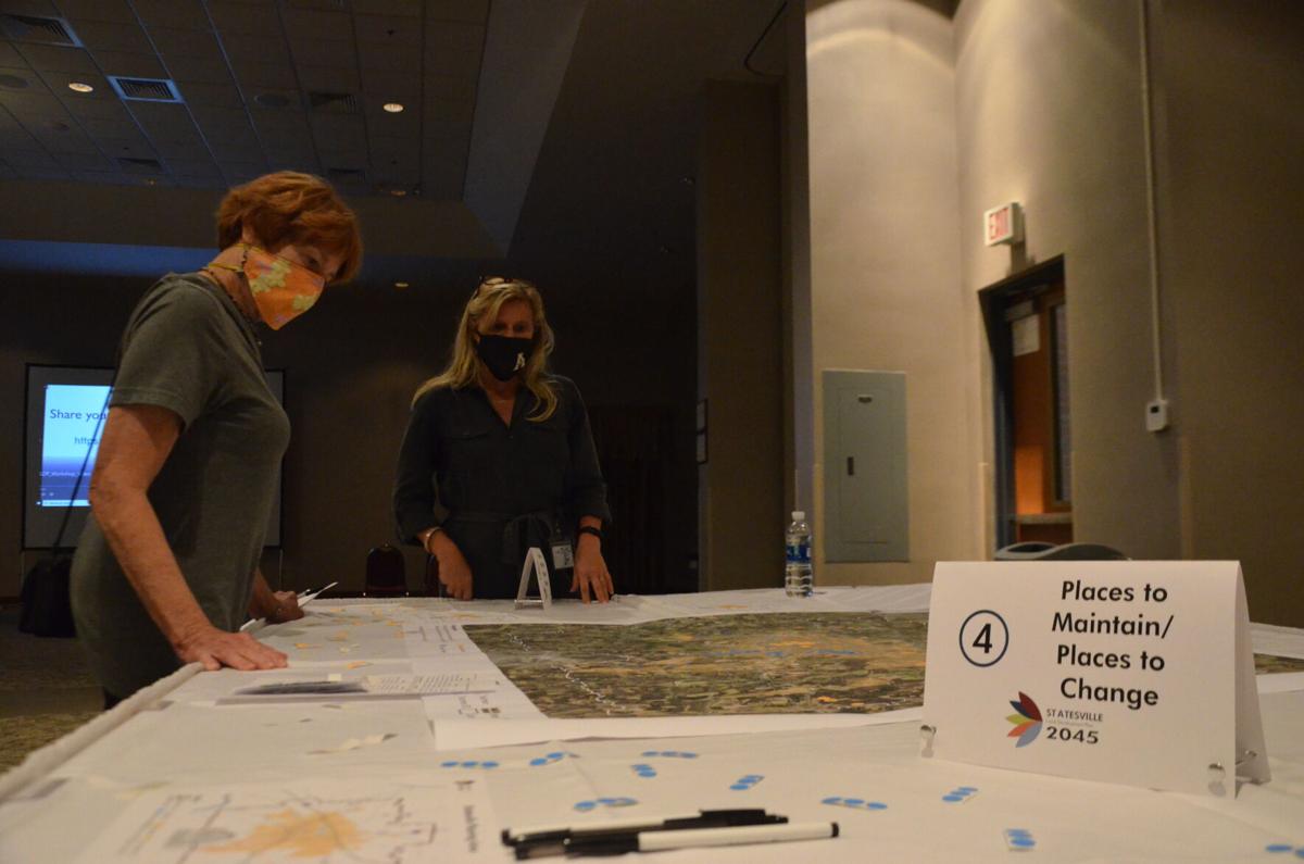 City of Statesville Planning Director Sherry Ashley talks to one of the vistors during the Land Development Plan Workshop at the Statesville Civic Center on Tuesday