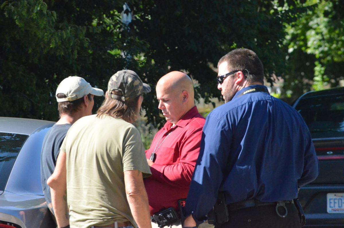 Sheriff's Deputies interview people near the scene of a homicide in Harmony.
