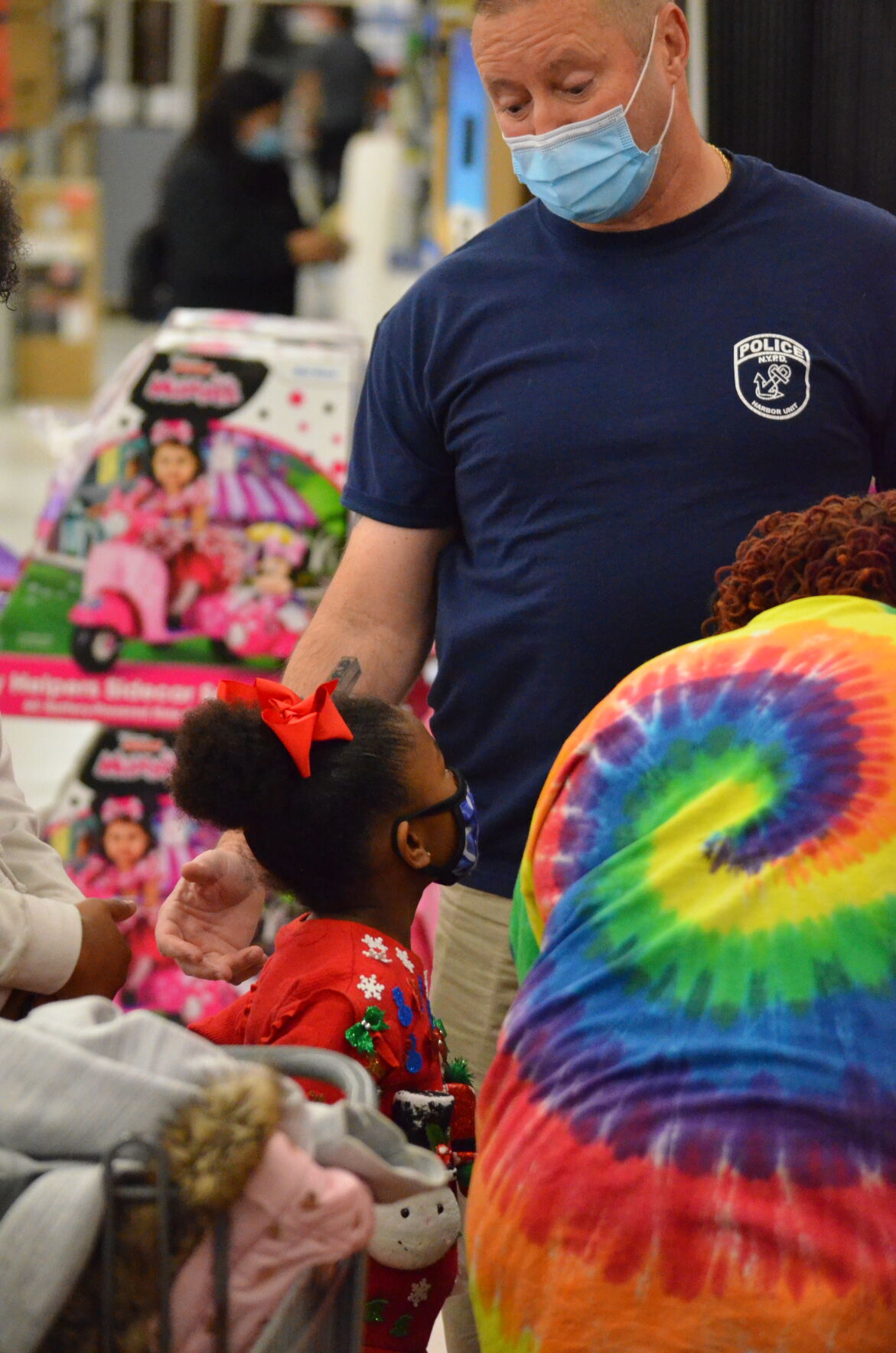 Vinny Slavik (right) talks with Khalea Murdock while to two shop during the annual Cops and Kids shopping program sponsored by the Iredell County Fraternal Order of Police.