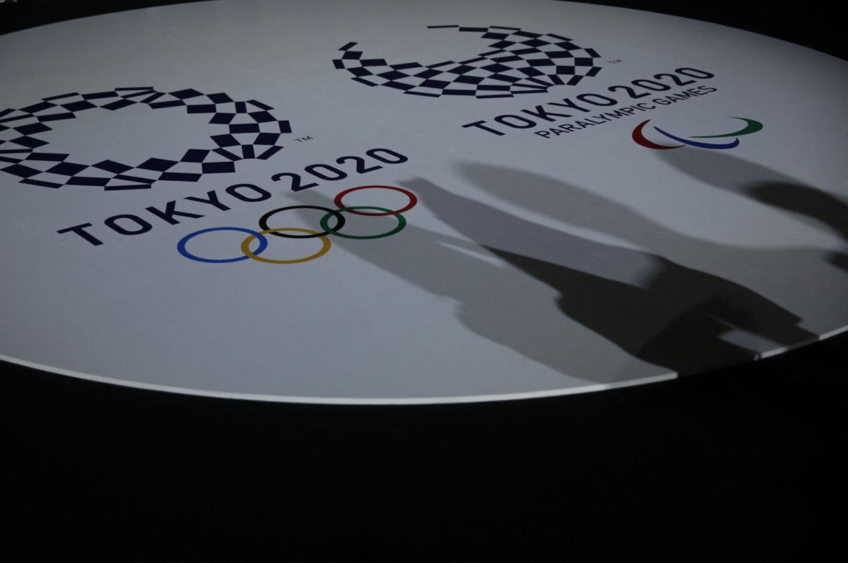 The emblems of the Tokyo 2020 Olympic and Paralympic Games are displayed during an event to unveil the medals, podium and music to be used for the medal ceremonies at the Tokyo 2020 Olympics Games at Ariake Arena in Tokyo on June 3, 2021.