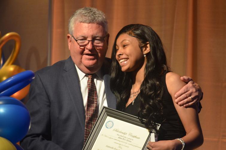 J. Douglas Hendrix presents a scholarship to Alana Blair-Barnes at the NAACP Statesville Branch Annual Freedom Fund and Awards Celebration in Statesville on Sunday.