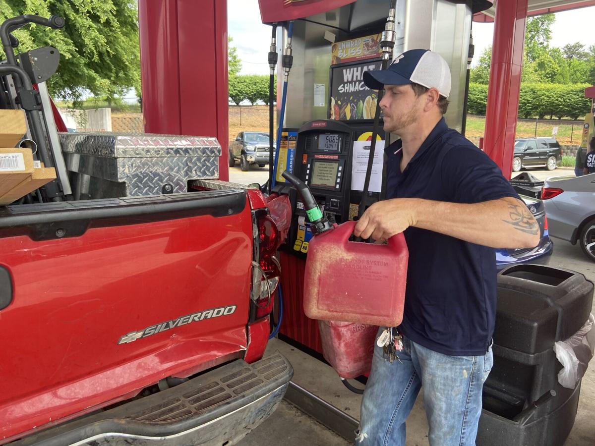 Devin Williams loads containers of fuel into his truck on Tuesday in Statesville.