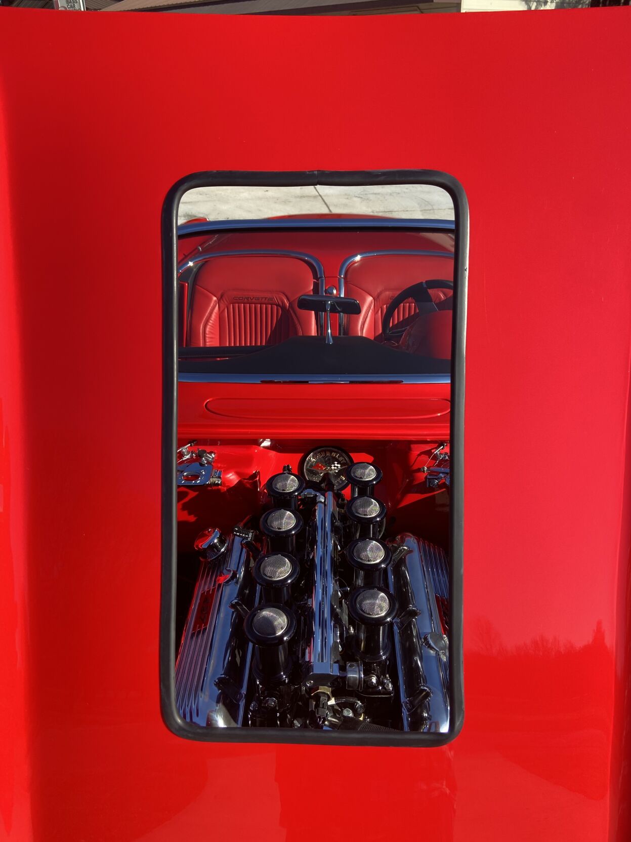 A peek at the engine of Jerry Lyndon's 1959 Chevrolet Corvette Custom through the raised-hood