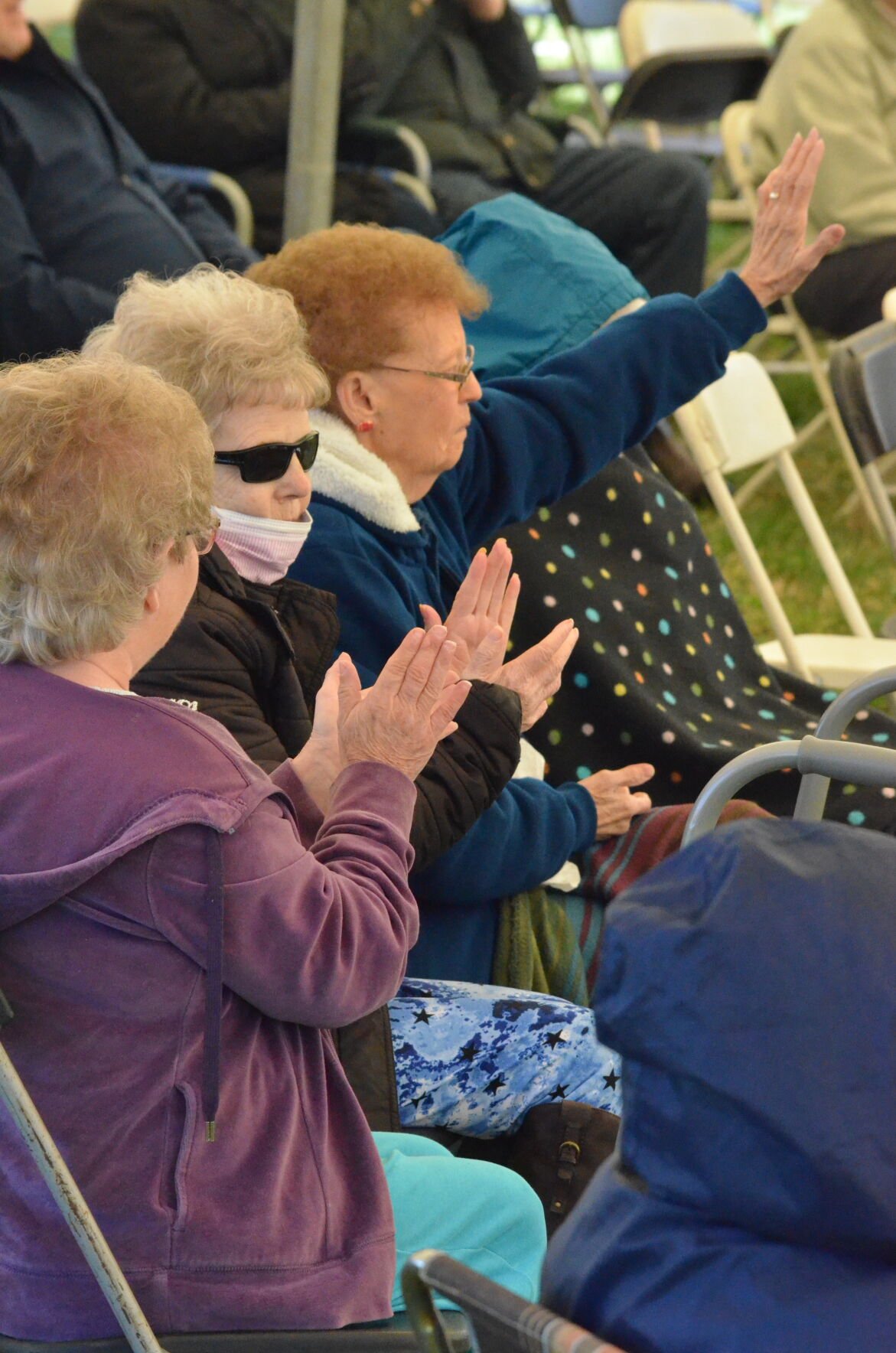 Audience members clap along as On Bended Knee performs at Harmony Hill Music Festival in Harmony on Saturday.