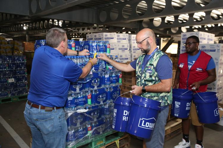 Lowe's employees fill pails with disaster relief supplies