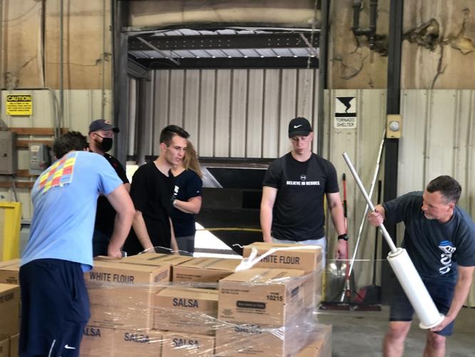Darren White wraps a pallet of food ready for distribution at the Fibrix in Statesville on Thursday.