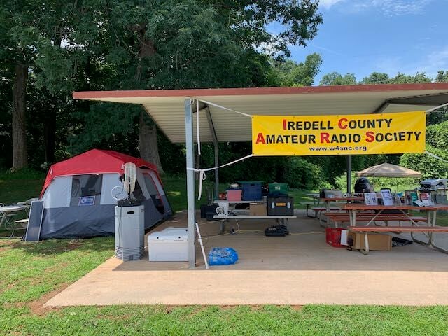 A banner hangs over a shelter at a previous Iredell County Amateur Radio Society Field Day event.