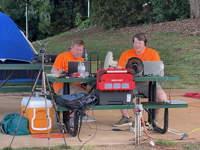 Mike Fisher, left, and Matthew Fisher take part in a previous Iredell County Amateur Radio Society Field Day event.