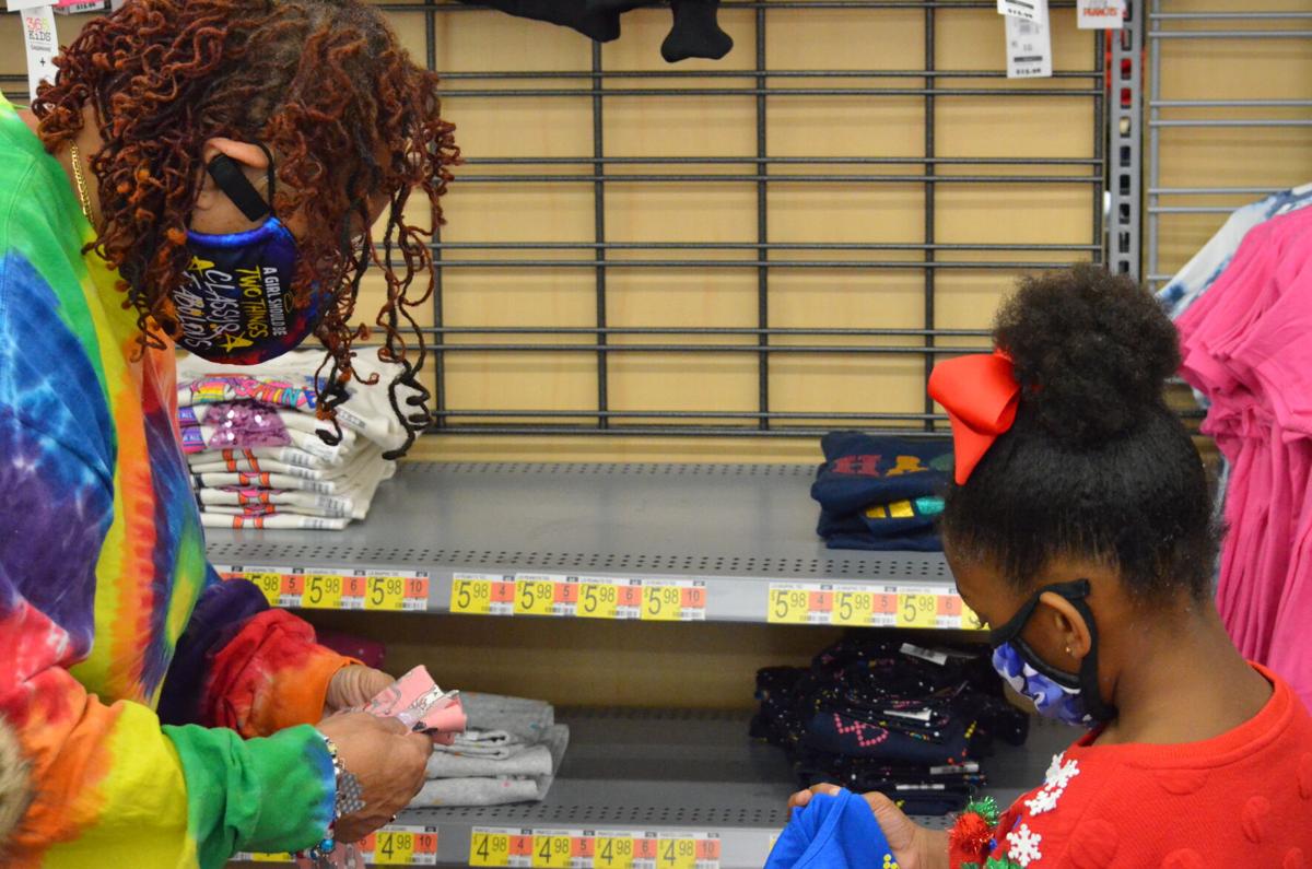 Iris Murdock (left) and Khalea Murdock look at clothes during the annual Cops and Kids shopping program sponsored by the Iredell County Fraternal Order of Police.