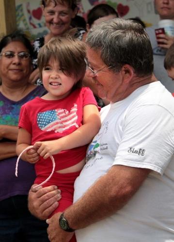 Alisa Maier held by her grandfather after she arrived home. 