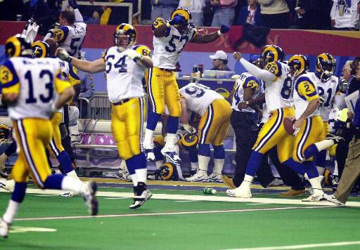 Former St. Louis Rams Isaac Bruce holds the Super Bowl trophy during  ceremonies celebrating the teams Super Bowl victory in the 1999-2000  season, at the Edward Jones Dome during half time of