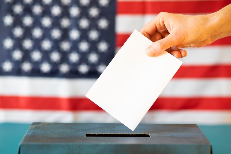 usa elections the hand of woman putting her vote in the ballot box (copy)