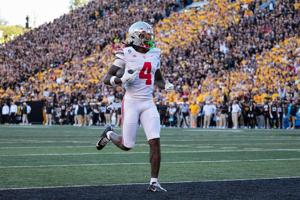 Ohio State wide receiver Jeremiah Smith (4) scores a touchdown against Iowa during the second half at Kinnick Stadium in Iowa